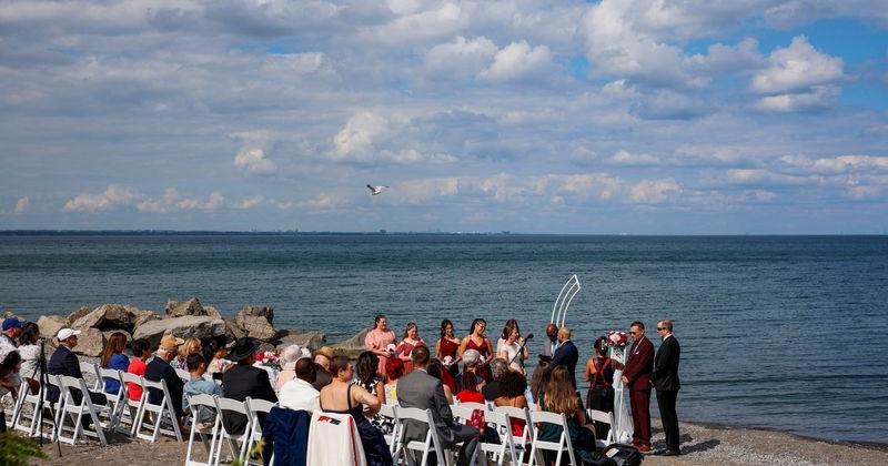 People walk along Lake Ontario shore after Trump orders name change to Lake America
