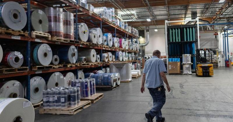 An employee at Emerald Packaging walks by rolls of plastic at the company’s facility in Union City