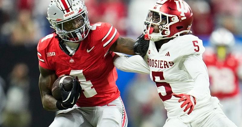 Ohio State Buckeyes wide receiver Jeremiah Smith (4) shakes off Indiana Hoosiers defensive back D'Angelo Ponds (5) during the Big Ten Conference championship game at Lucas Oil Stadium in Indianapolis on Dec. 6, 2025. Ohio State lost 13-10.