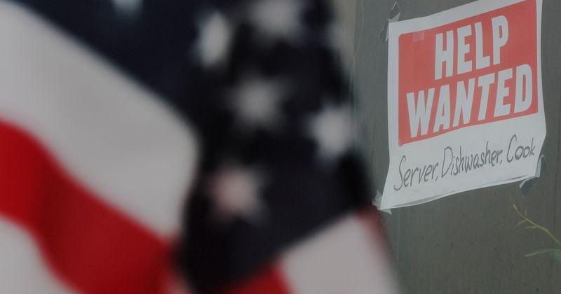 A “Help Wanted” sign hangs in restaurant window in Medford