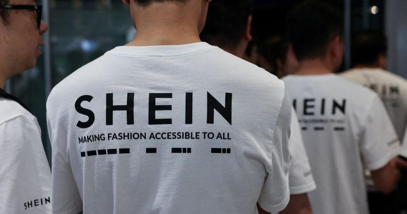 Staff wear T-shirt featuring the logo of online fashion retailer Shein during its listing ceremony at the Hong Kong Stock Exchange in Hong Kong