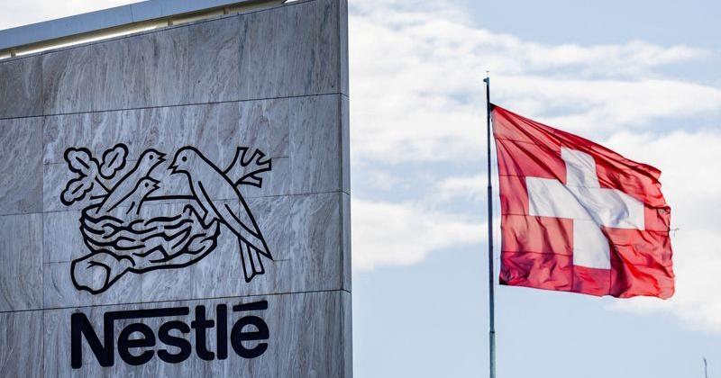 FILE PHOTO: A Swiss flag flutters on the headquarters of Nestle in Vevey
