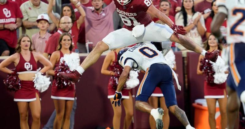 Oklahoma's Rocky Beers (81) leaps over UTEP's Justin Content (0) as he runs in for a touchdown after a catch in the first half
