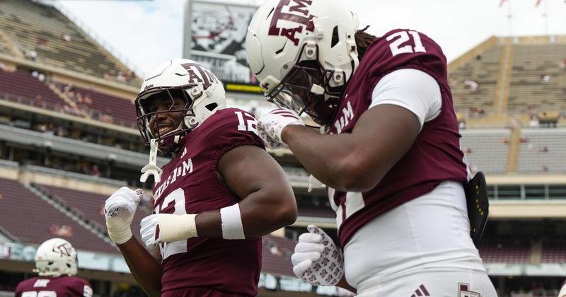 Sep 6, 2025; College Station, Texas, USA; Texas A&M Aggies defensive end Nana Boadi-Owusu (12) and Texas A&M Aggies tight end Kiotti Armstrong (21) dancing during pregame against the Utah State Aggies at Kyle Field. Mandatory Credit: Sean Thomas-Imagn Images