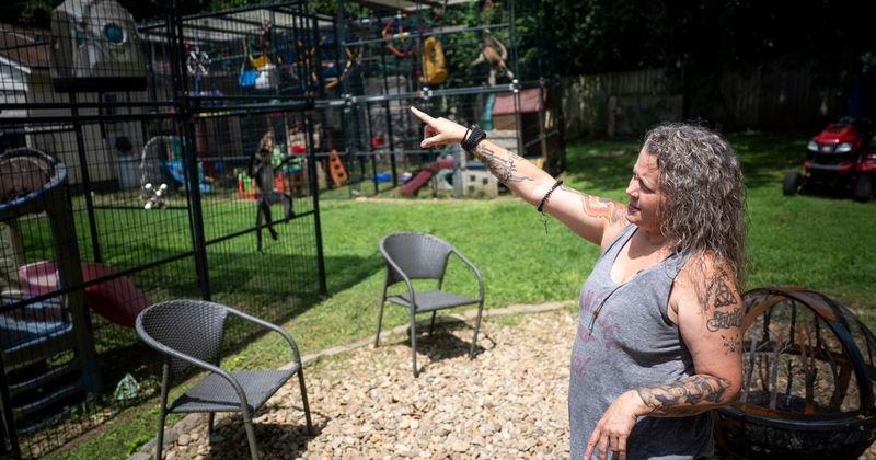 Jamie Fuller points out features on the enclosures housing her 30 monkeys at her north Knoxville home on Aug. 14, 2026. Knoxville Chief Operating Officer Grant Rosenburg is proposing an ordinance amendment to put an end to city residents being allowed to own more than four monkeys.