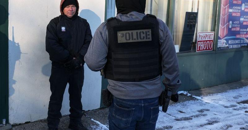 Federal agents question a man, during immigration removal operations in the Long Island town of Hempstead, New York