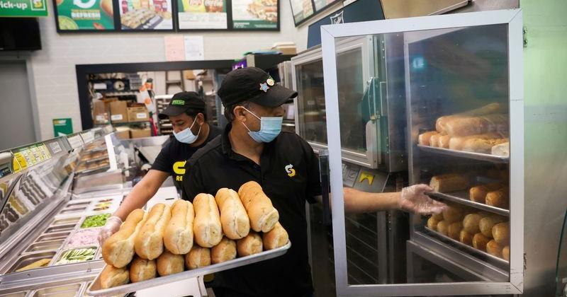 Servers work at a Subway restaurant in Manhattan, New York City