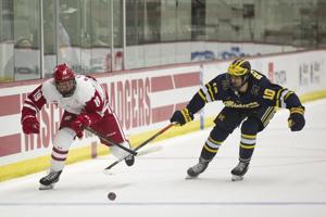 badgers caufield brock skates beniers puck matty alongside