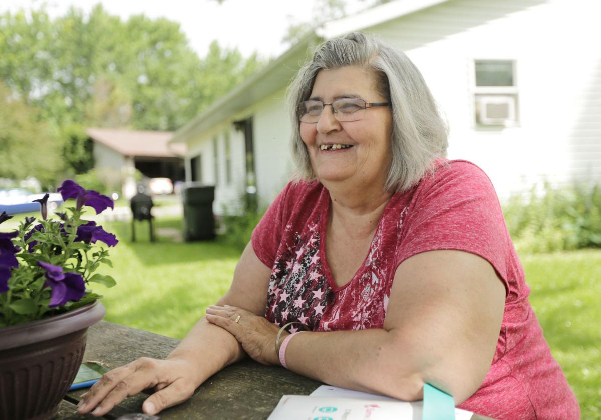 Sally sitting outside of her house