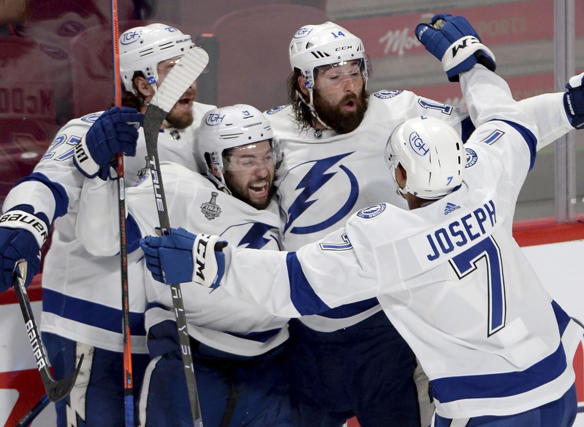 Lightning defenseman Erik Cernak, front, celebrates his goal along with  right wing Nikita Kucherov after Cernak beat Canadiens goaltender Carey  Price to score in Game 1 of the Stanley Cup final. (Photo