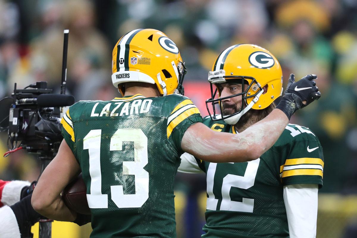 Jan 2, 2022; Green Bay, Wisconsin, USA; Green Bay Packers quarterback Aaron Rodgers (12) celebrates with wide receiver Allen Lazard (13) after a touchdown in the second quarter against the Minnesota Vikings at Lambeau Field. Mandatory Credit: Benny Sieu-USA TODAY Sports