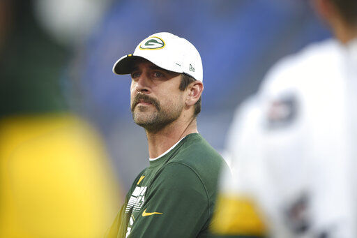 Aaron Rodgers sidelines in street clothes, AP photo