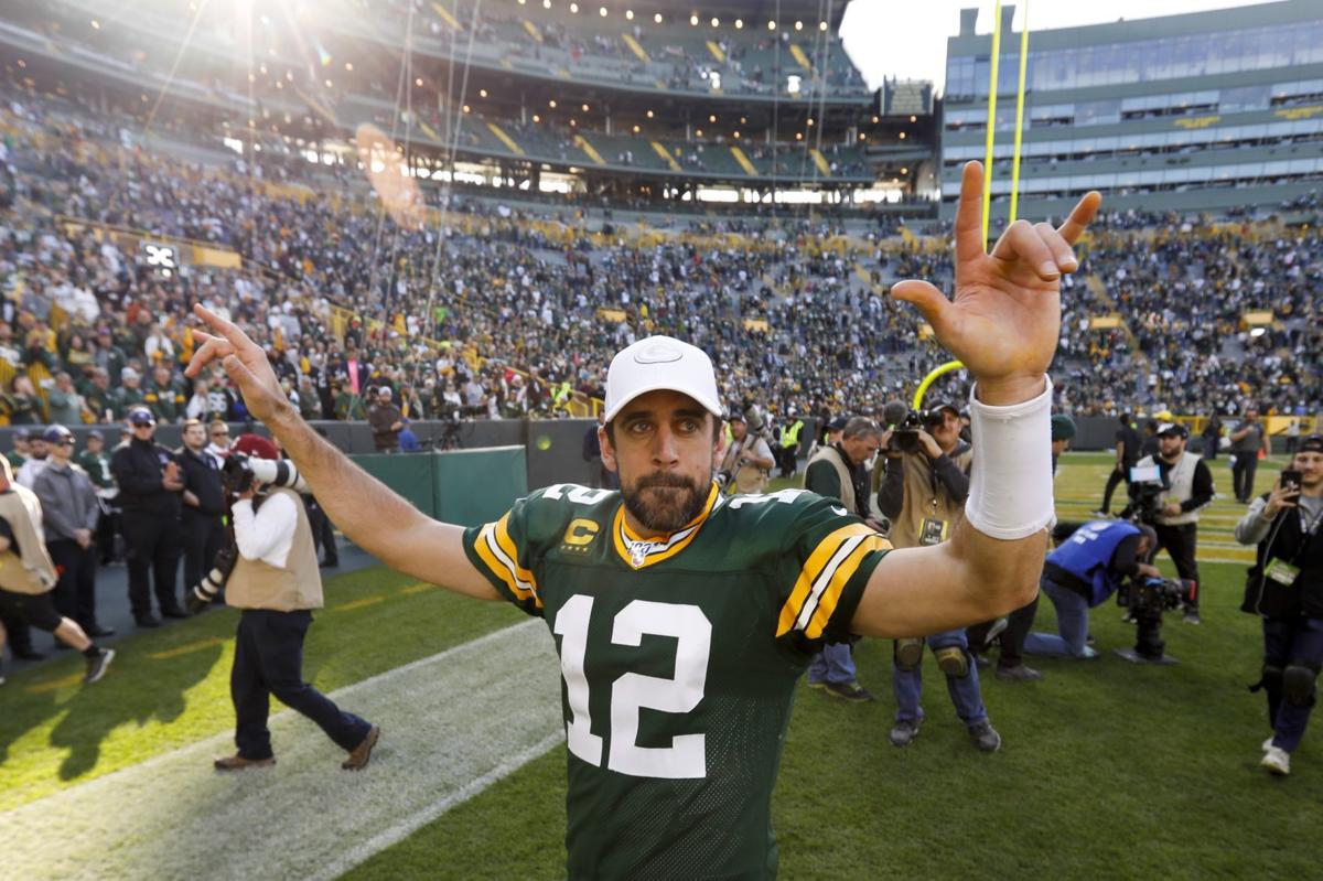 Aaron Rodgers arms high after Raiders win, AP photo
