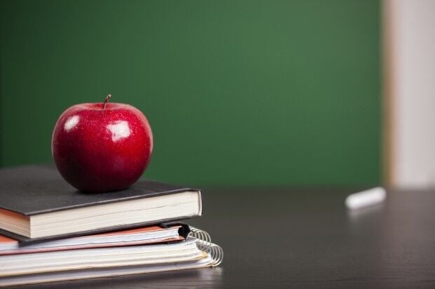 School book and apple, generic file photo