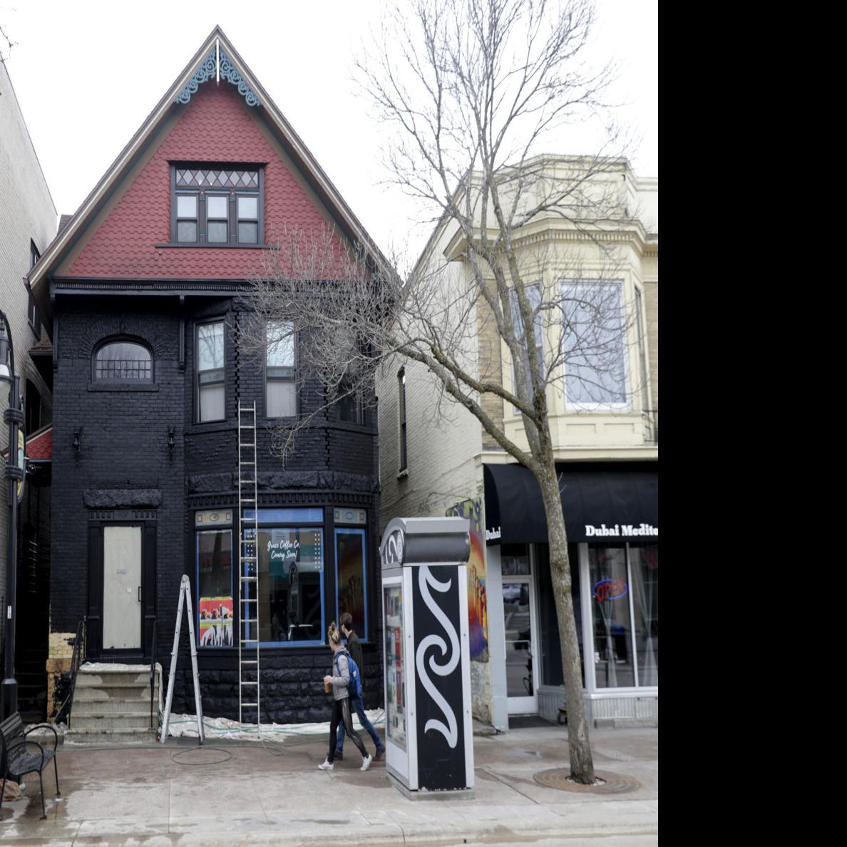 Old Sacred Feather Building Covered In Black Paint In Violation Of