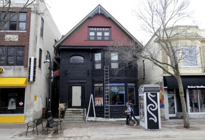 Old Sacred Feather Building Covered In Black Paint In