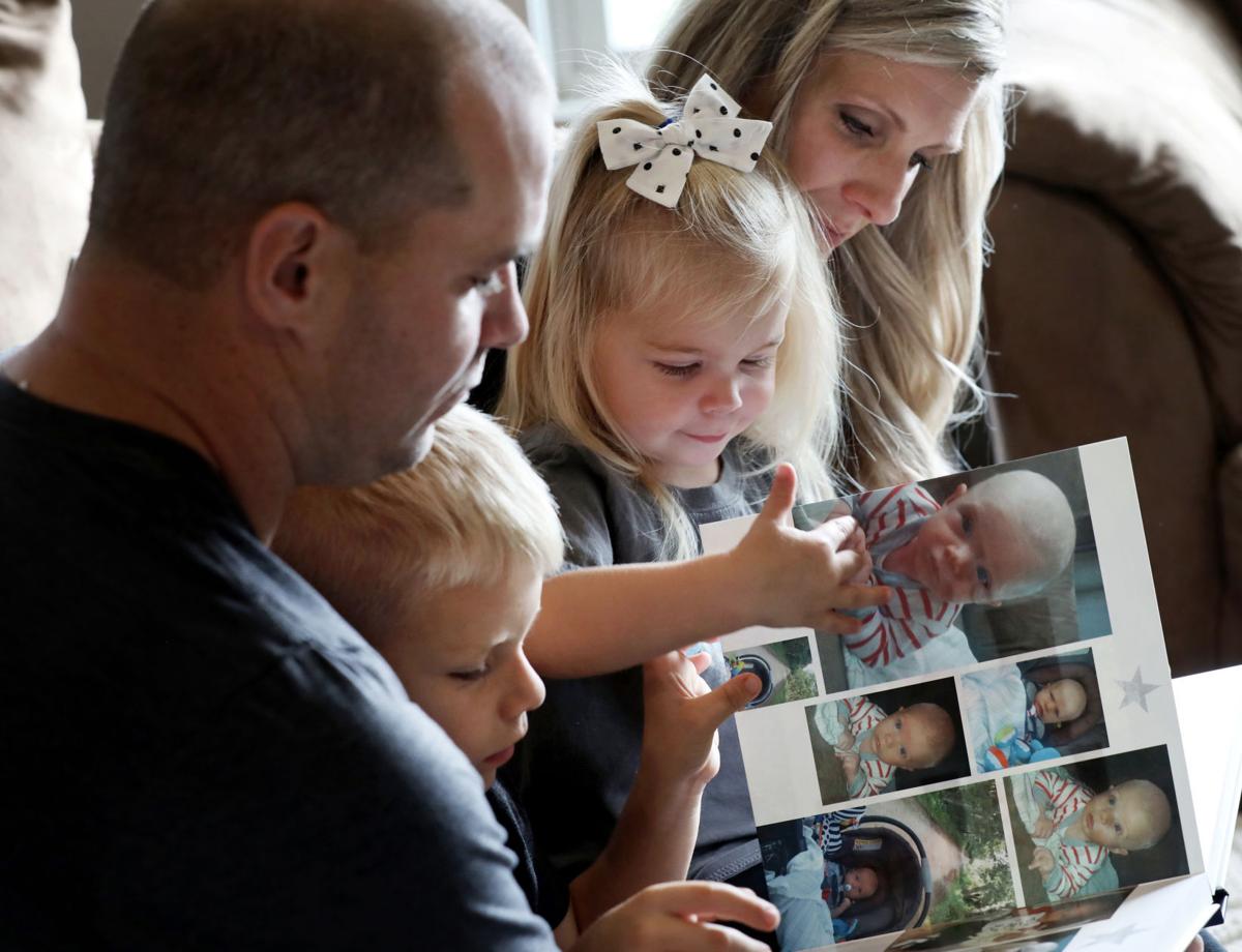 Heckendorf family looking at photo album