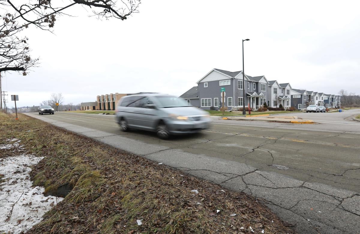 Workmen install crossing so bad people walk in the road to avoid