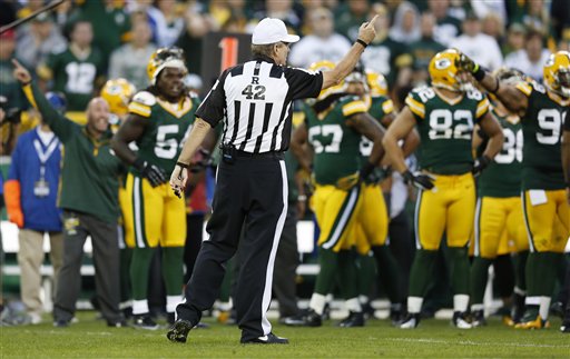 Referee Jeff Triplette signals New Orleans Saints' possession, after a  video review, during the second half of the Saints' NFL football game  against the Green Bay Packers on Sunday, Sept. 30, 2012