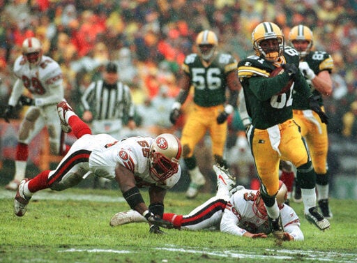 San Francisco 49ers quarterback Colin Kaepernick throws a pass during the  fourth quarter of the NFC Wildcard Playoff against the Green Bay Packers at  Lambeau Field in Green Bay, Wisconsin on January