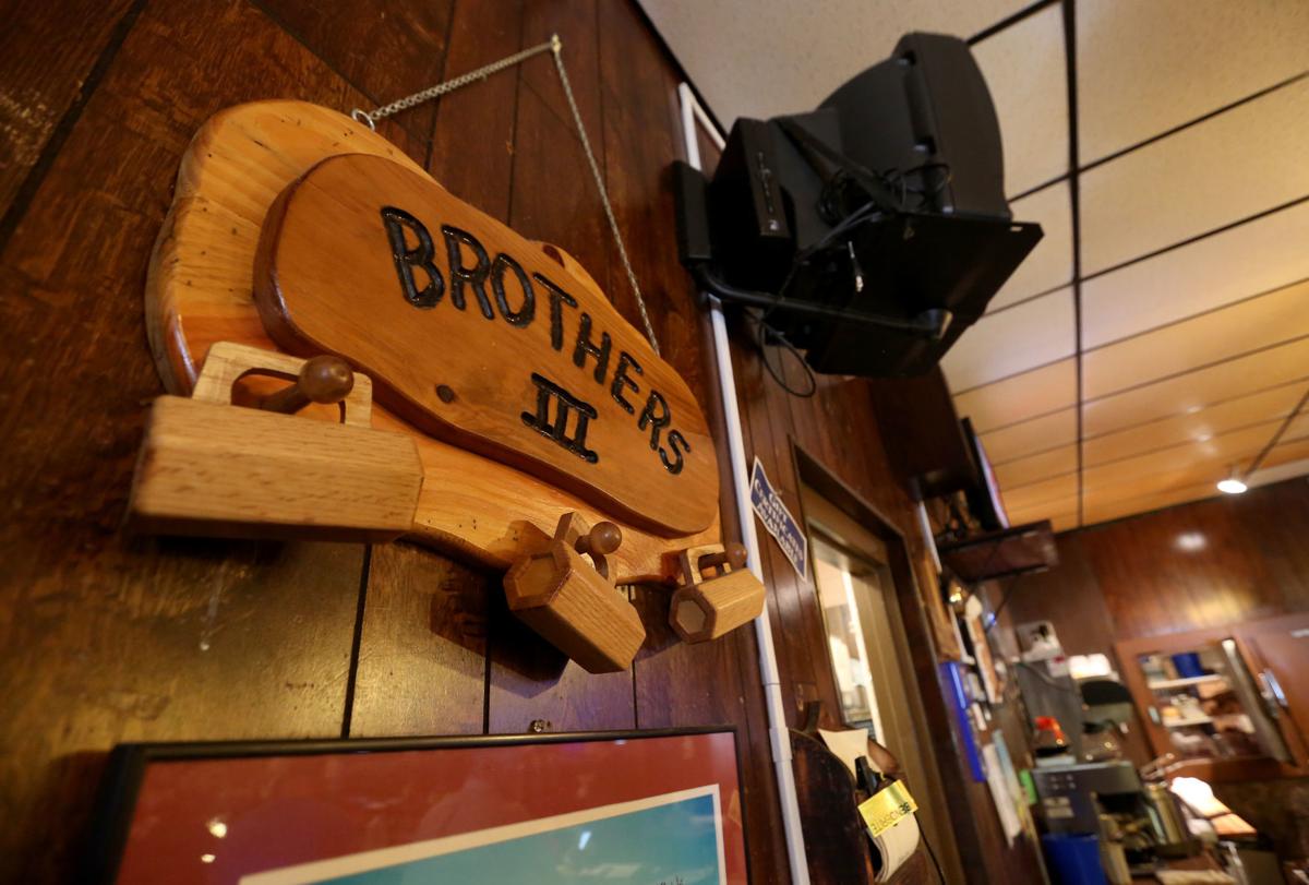 A plaque hangs on the wall near the entrance to the bar area at