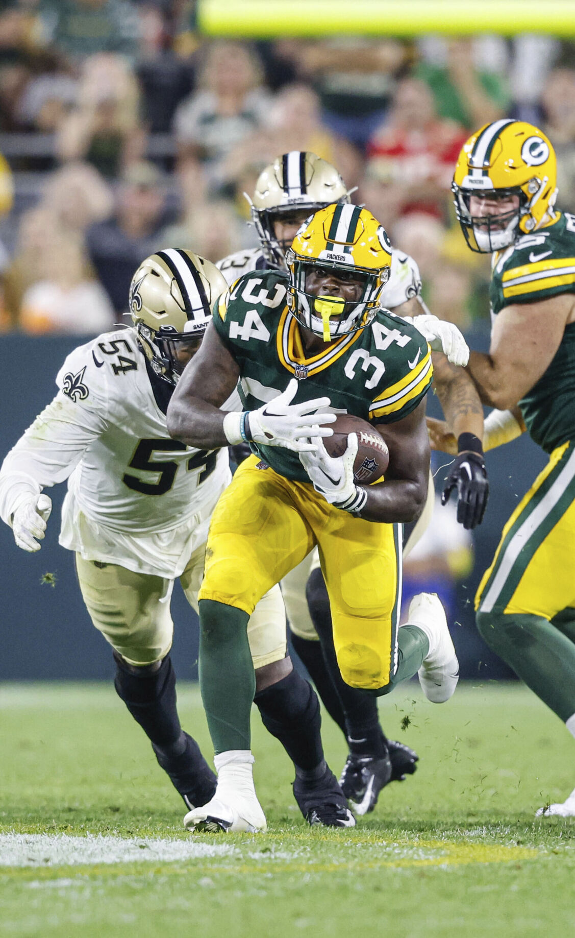 Green Bay Packers quarterback Danny Etling (19) runs for a touchdown during  an NFL Preseason game against the New Orleans Saints Friday, Aug. 19, 2022,  in Green Bay, Wis. (AP Photo/Jeffrey Phelps