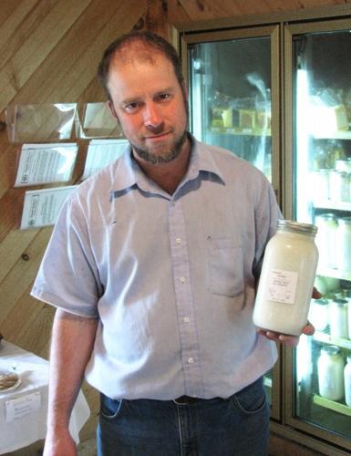 Loganville farmer Hershberger holds raw milk
