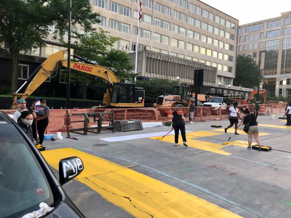 Protest By Painting Demonstrators Spell Out Demand On Downtown
