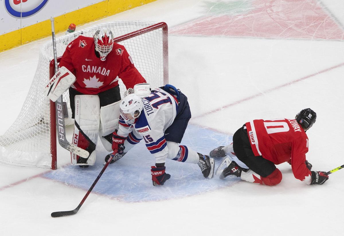 Canada's Dylan Holloway (10) and Russia's Vasili Podkolzin (19) compete for  the puck during the first period of a game leading up to the IIHF World  Junior Hockey Championships, Wednesday, Dec. 23