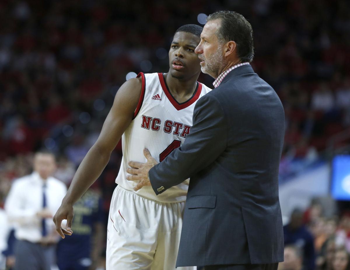 North Carolina State head coach Mark Gottfried talks with Dennis Smith Jr. (4) during action against Georgia Southern at the PNC Center in Raleigh, N.C., on November 11, 2016.