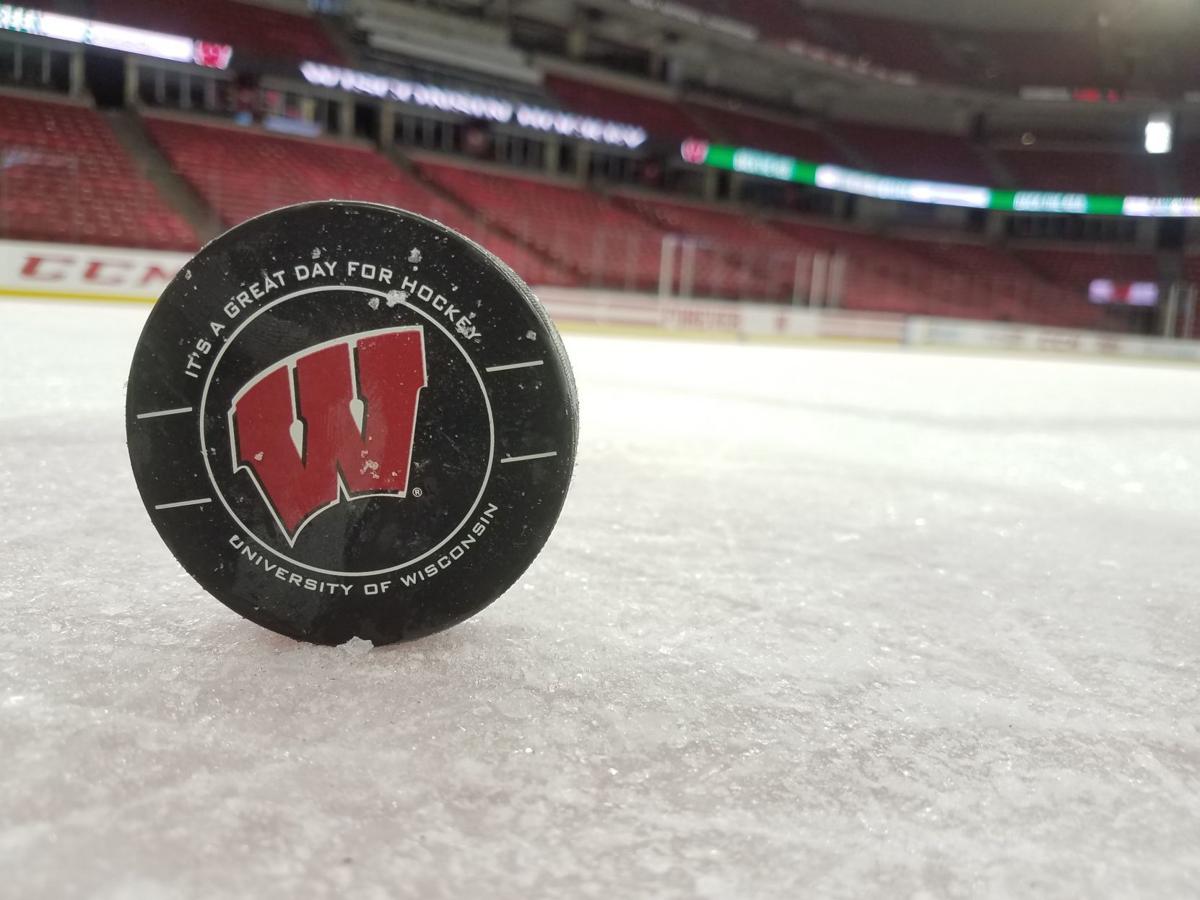 Badgers men's hockey puck 4, generic file photo, Badgers women's hockey puck 4