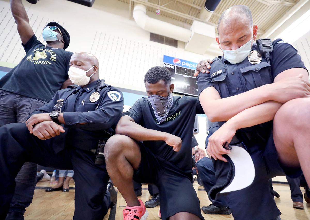 Community and police leaders kneel for George Floyd