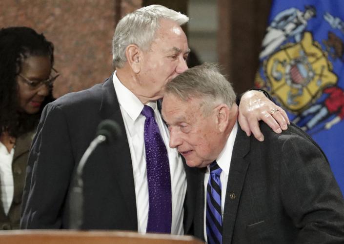Former governors embrace at inauguration ceremony