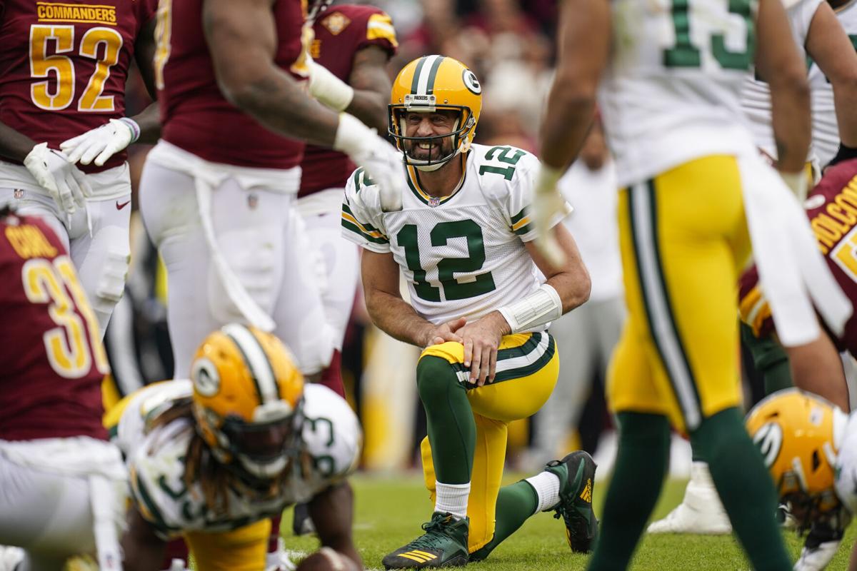 Washington Commanders quarterback Taylor Heinicke (4) throws under pressure  from Green Bay Packers linebacker Rashan Gary (52) during the first half of  an NFL football game Sunday, Oct. 23, 2022, in Landover