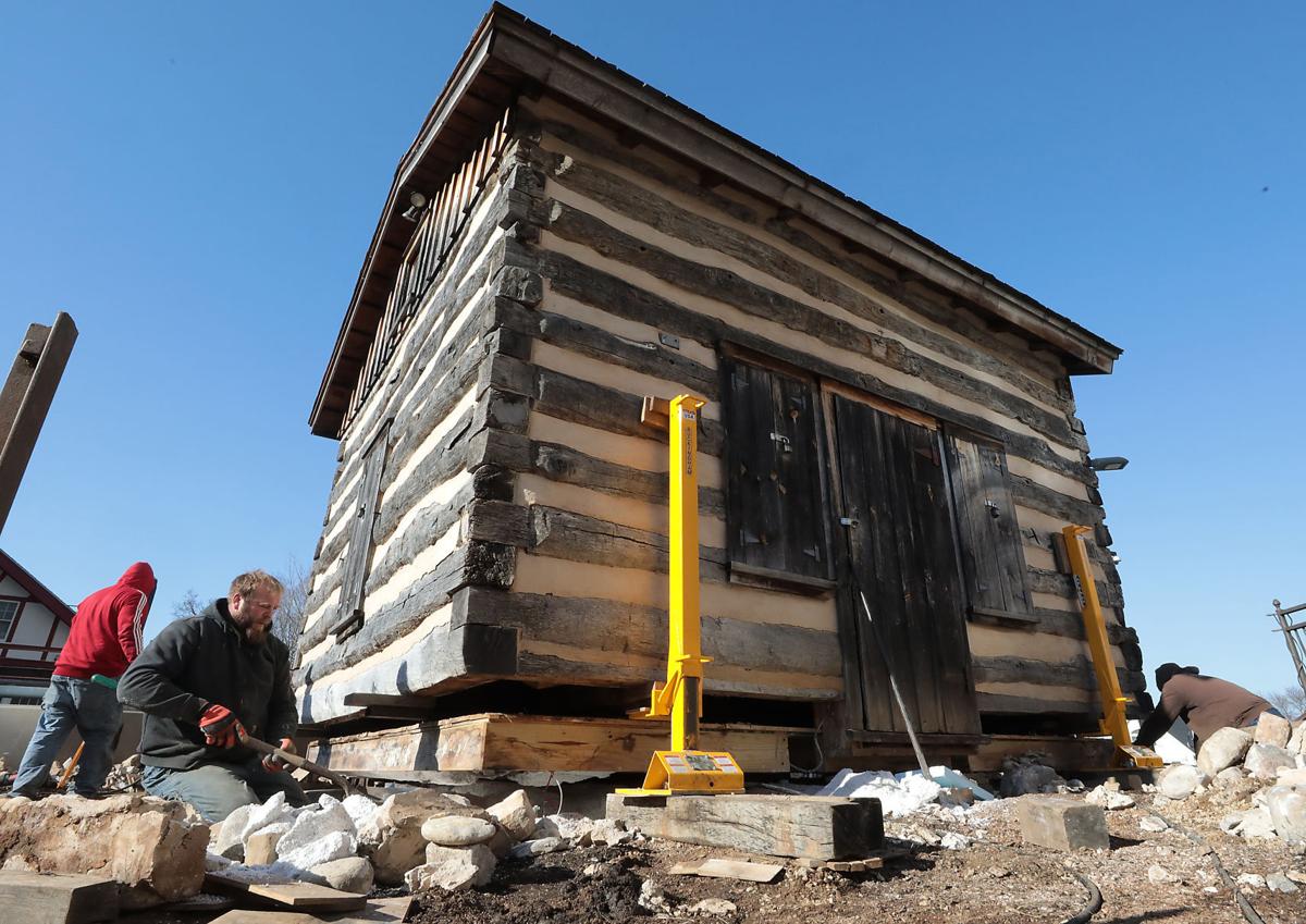 Jacks placed under log cabin