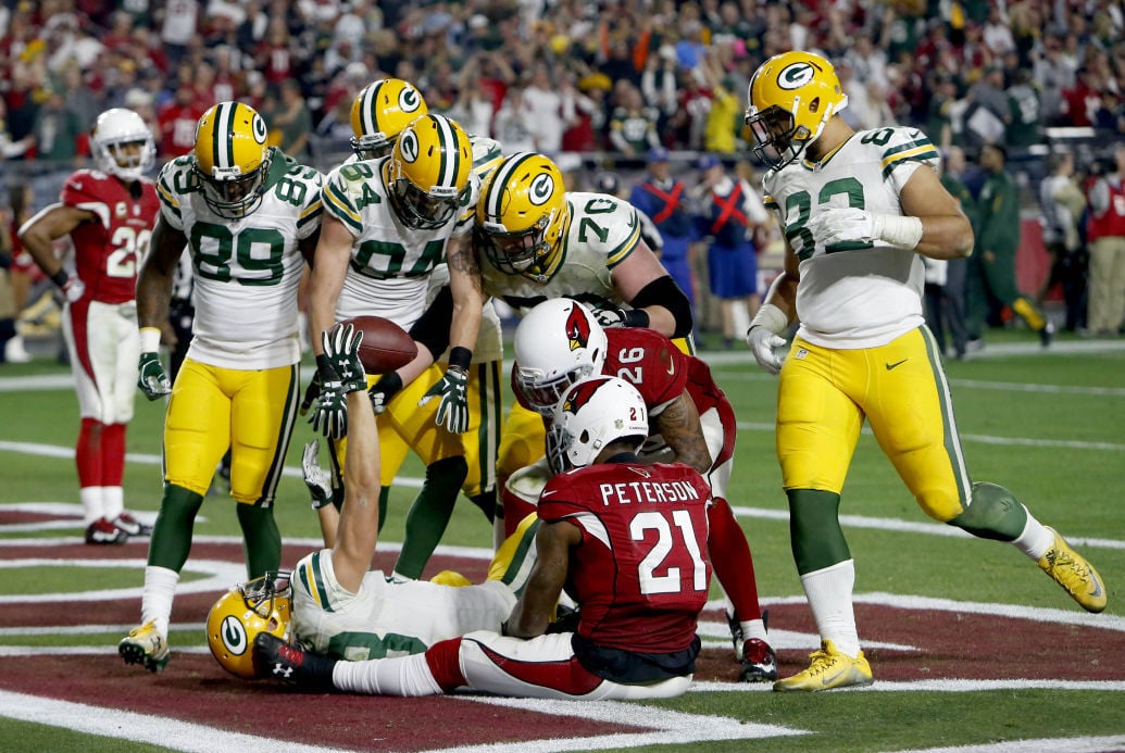 Jeff Janis holds up ball after Hail Mary catch, AP photo