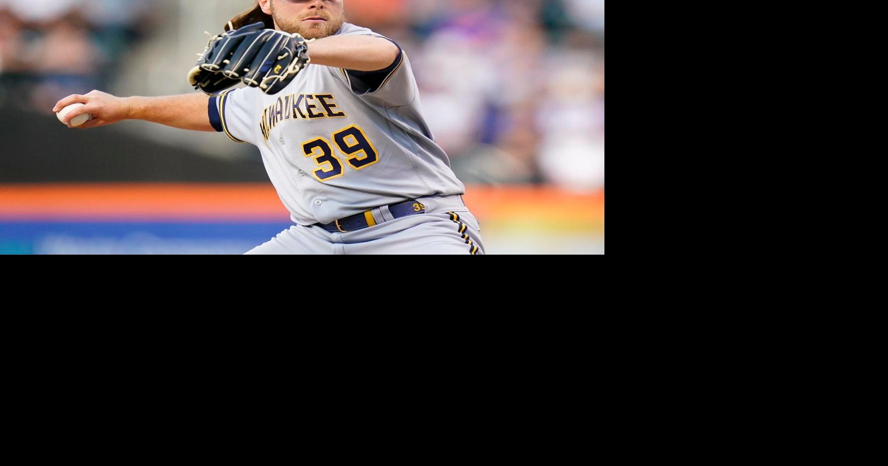 Milwaukee Brewers starter Corbin Burnes adjusts his hair as he pitches  against the Pittsburgh Pirates during the first inning of a baseball game,  Tuesday, Aug. 2, 2022, in Pittsburgh. (AP Photo/Keith Srakocic
