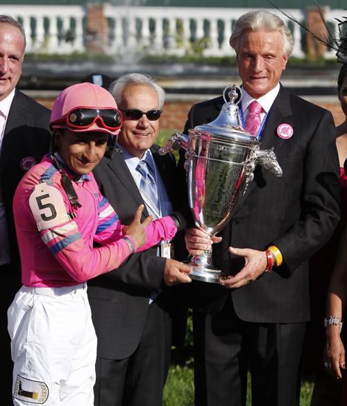 From left, jockey Rafael Bejarano, trainer Jerry Hollendorfer, and owner Mark DeDominco, raise the Oaks trophy after Blind Luck, with Bejarano aboard, won at Churchill Downs in Louisville, Ky., on April 30, 2010.