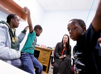 April Johnson and sons in room with therapist