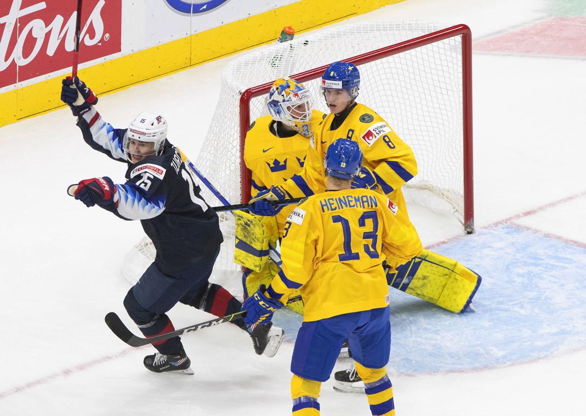 United States' Cole Caufield (13), Matthew Boldy (12) and Matthew Beniers  (10) celebrate a goal against Austria during during the second period of an  IIHF World Junior Hockey Championship game Saturday, Dec.