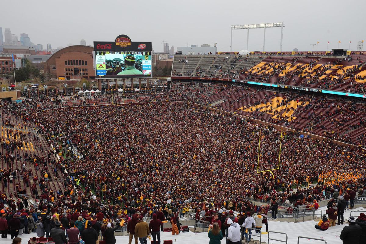 Minnesota Golden Gophers and fans storm the field while hoisting the Governor's Victory Bell after defeating the Penn State Nittany Lions 31-26 to remain undefeated at TCFBank Stadium on November 9, 2019 in Minneapolis, Minnesota.