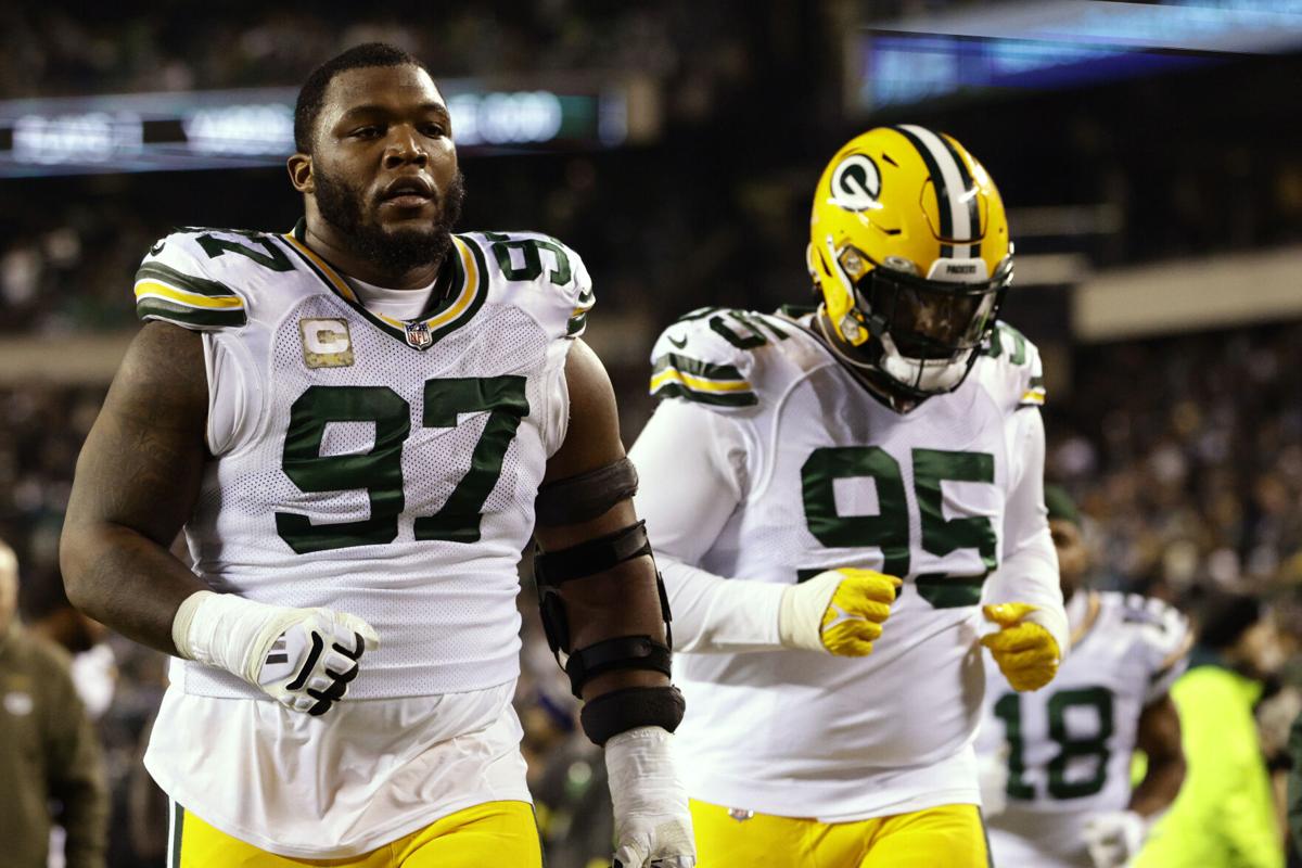 Packers lineman Kenny Clark surrounded by youngsters