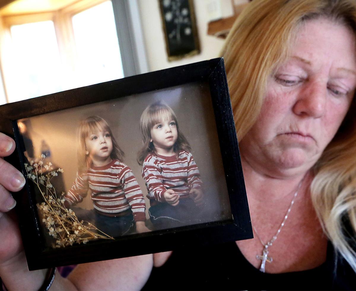 Sherri holding photo of sons