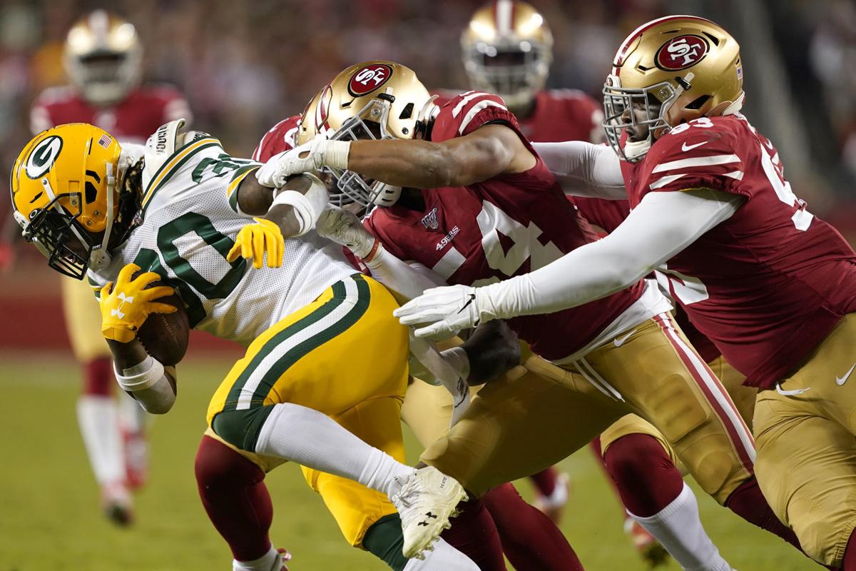 Jamaal Williams tackled by 49ers, AP photo