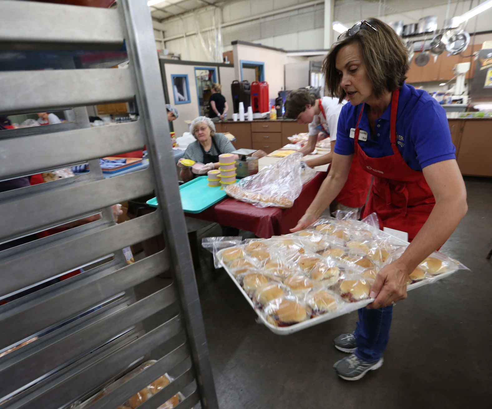 Julie McCoubrey, Lunch Program Manager, Puts A Tray Of Sandwiches For ...