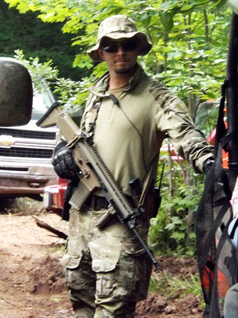 Security guard with high-powered rifle at mine site