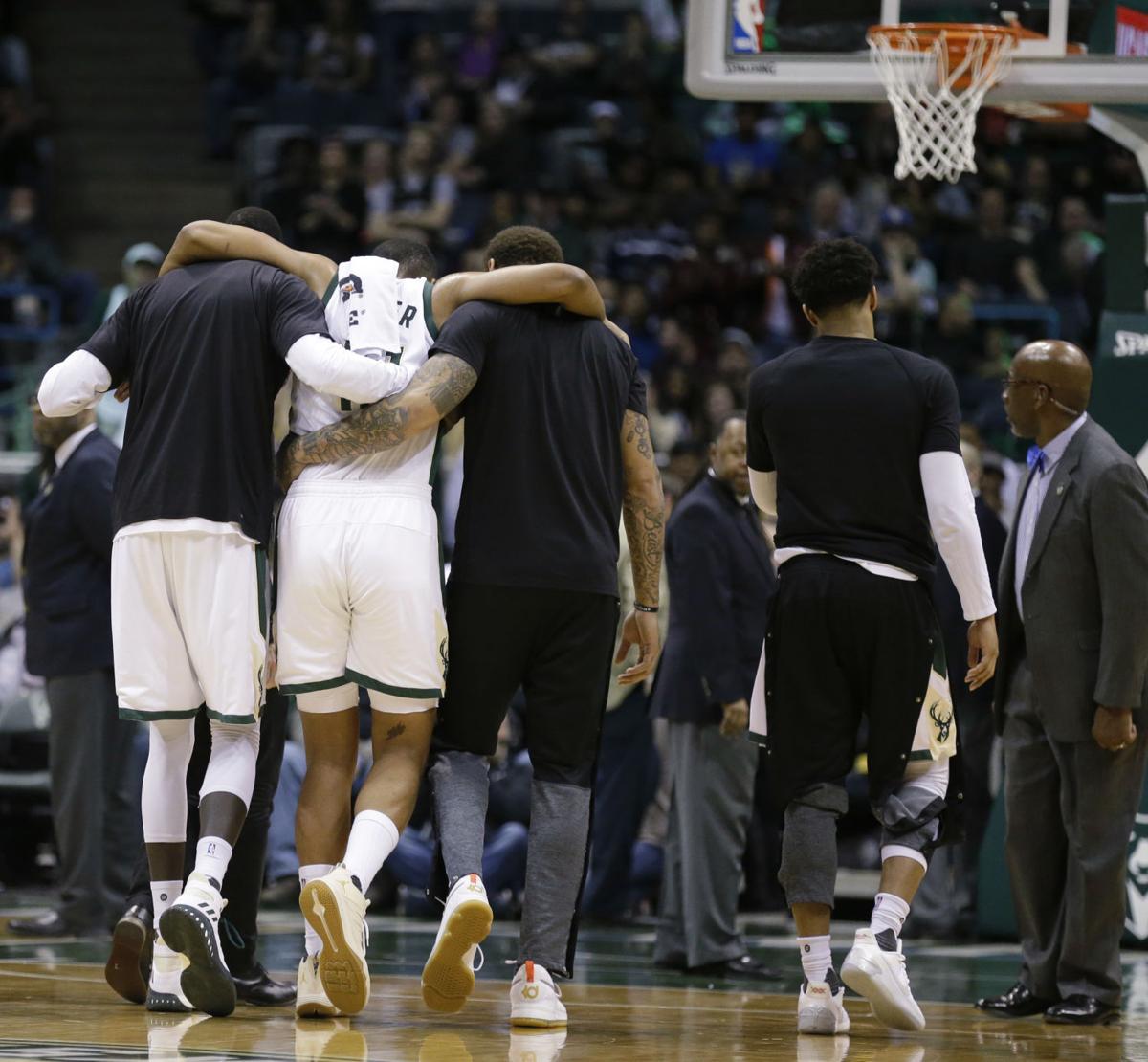 Jabari Parker carried off court knee injury, AP photo