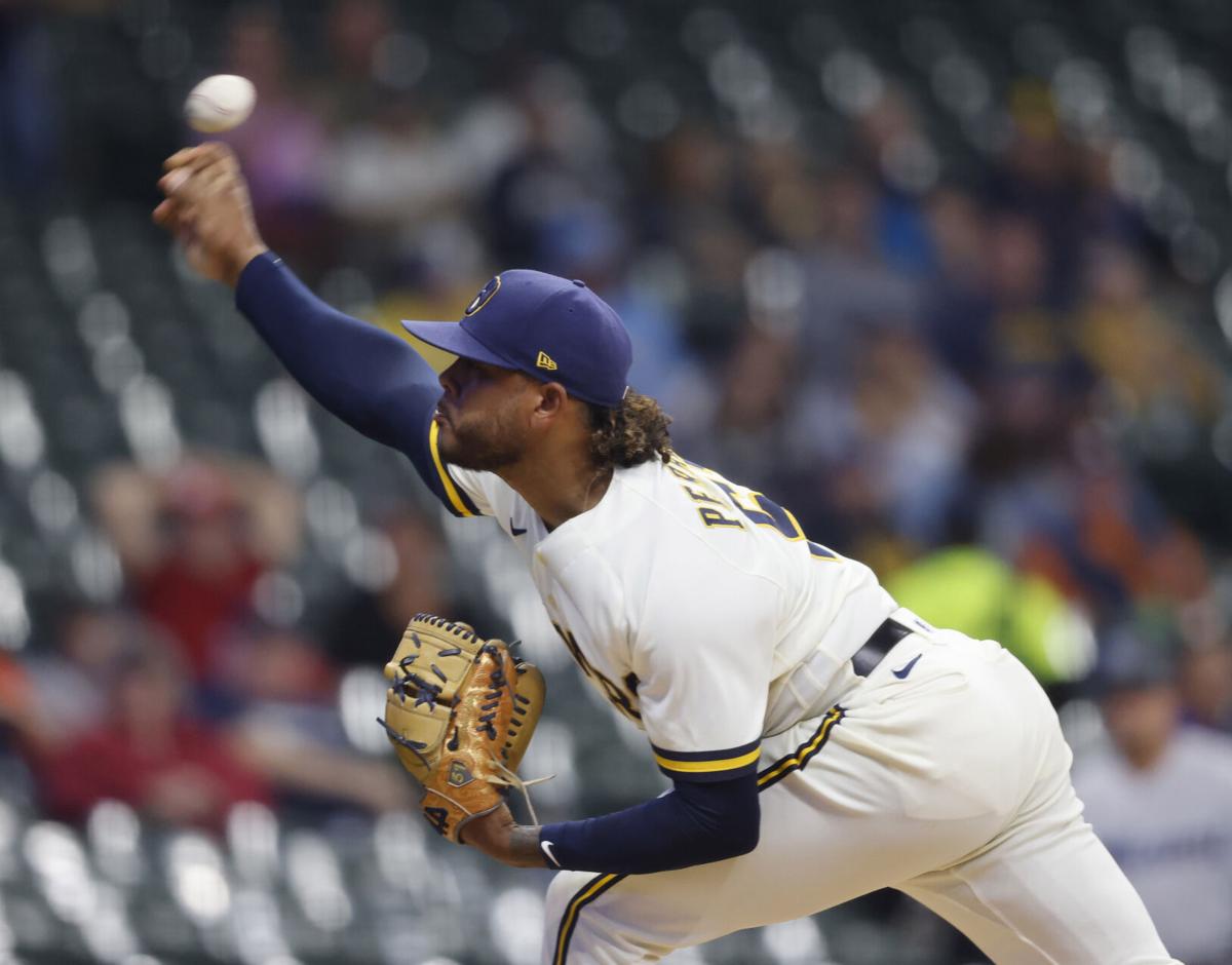 Brewers get winning streak started with extra inning win over Marlins
