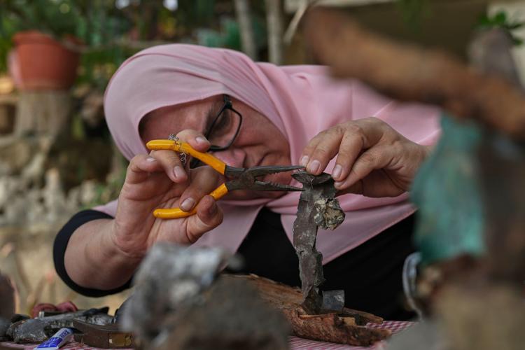 Lebanese artist turns shrapnel from Israeli munitions into art, in ...