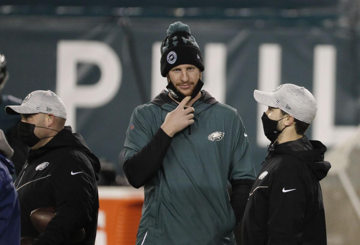 Philadelphia Eagles quarterback Carson Wentz lowers his face mask before the team's game Sunday night against the Washington Football Team on Jan. 3, 2021.